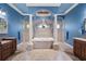 Luxurious main bathroom featuring a soaking tub, dual vanities, and elegant architectural details at 10117 Breezy Pines Ct, Weeki Wachee, FL 34613