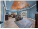 Large main bedroom with seating area, fireplace, ceiling fan, and access to the patio at 10117 Breezy Pines Ct, Weeki Wachee, FL 34613