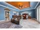 Spacious main bedroom features a seating area, tray ceiling, and ensuite bathroom at 10117 Breezy Pines Ct, Weeki Wachee, FL 34613