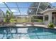 Enclosed pool area with two wood lounge chairs and beautiful backyard views at 10117 Breezy Pines Ct, Weeki Wachee, FL 34613