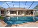 Beautiful pool area with rock spa, turtles and fish art and outdoor seating at 10117 Breezy Pines Ct, Weeki Wachee, FL 34613