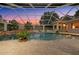 Inviting screened pool area with a waterfall feature and spacious brick patio, perfect for outdoor relaxation at 10117 Breezy Pines Ct, Weeki Wachee, FL 34613