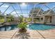 Enclosed pool and patio area with brick pavers, tropical plants and outdoor bar at 10117 Breezy Pines Ct, Weeki Wachee, FL 34613