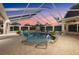 Enclosed pool with spa, waterfall feature, plants, and brick pavers at 10117 Breezy Pines Ct, Weeki Wachee, FL 34613