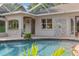 The enclosed pool area features an in-pool bar and backyard views at 10117 Breezy Pines Ct, Weeki Wachee, FL 34613