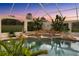 Enclosed pool with spa, waterfall feature, and lush green plants at 10117 Breezy Pines Ct, Weeki Wachee, FL 34613