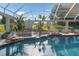 Pool featuring a rock waterfall and spa, surrounded by mature landscaping at 10117 Breezy Pines Ct, Weeki Wachee, FL 34613