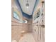 The walk-in shower features multiple shower heads and is accented by arched windows at 10117 Breezy Pines Ct, Weeki Wachee, FL 34613