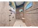A luxurious walk-in shower boasts multiple shower heads and a built-in bench at 10117 Breezy Pines Ct, Weeki Wachee, FL 34613