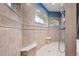 Walk-in shower with a corner bench and arch windows to let the light shine through at 10117 Breezy Pines Ct, Weeki Wachee, FL 34613