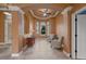 Inviting sitting area with a tray ceiling, arched doorways, neutral tones, and a window view offering a cozy retreat at 10117 Breezy Pines Ct, Weeki Wachee, FL 34613
