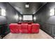 Luxurious home theater room equipped with projector, screen, and recliner seating for the perfect viewing experience at 10117 Breezy Pines Ct, Weeki Wachee, FL 34613
