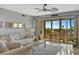 Light-filled living room with a balcony showcasing stunning water views at 10355 Paradise Blvd # 413, Treasure Island, FL 33706