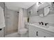 Bathroom featuring a white vanity, round mirror, toilet, and walk-in shower at 10355 Paradise Blvd # 413, Treasure Island, FL 33706