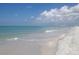 Picturesque beach scene with blue sky, calm waves, and soft sand, perfect for relaxation and recreation at 10355 Paradise Blvd # 413, Treasure Island, FL 33706
