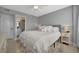 Comfortable bedroom featuring a queen-sized bed with soft bedding and a view into the bathroom at 10355 Paradise Blvd # 413, Treasure Island, FL 33706