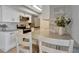 Modern kitchen featuring white cabinets and stainless steel appliances and breakfast bar at 10355 Paradise Blvd # 413, Treasure Island, FL 33706
