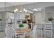 Charming dining area with views into the modern kitchen at 10355 Paradise Blvd # 413, Treasure Island, FL 33706