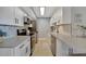 Bright, remodeled kitchen with white cabinets, stainless steel appliances and subway tile backsplash at 10355 Paradise Blvd # 413, Treasure Island, FL 33706