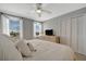 Comfortable main bedroom features a ceiling fan, nice view and a dresser at 10355 Paradise Blvd # 413, Treasure Island, FL 33706