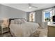 Bright and cozy main bedroom with plush bedding, stylish decor, and abundant natural light at 10355 Paradise Blvd # 413, Treasure Island, FL 33706