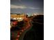 Illuminated night view of an upscale community highlighting scenic walking trails and city skyline in the background at 10355 Paradise Blvd # 413, Treasure Island, FL 33706