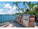 Enjoy the convenience of an outdoor kitchen with grills, set against a beautiful waterfront backdrop at 10355 Paradise Blvd # 413, Treasure Island, FL 33706