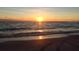 Golden sunset over the ocean horizon, creating a stunning and serene beach landscape at 10355 Paradise Blvd # 413, Treasure Island, FL 33706