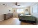 Comfortable bedroom featuring wood-look floors, neutral paint, a ceiling fan, and plenty of natural light at 11029 90Th Ave, Seminole, FL 33772