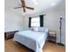 Bright bedroom with hardwood floors, complemented by natural light and ceiling fan for added comfort at 11029 90Th Ave, Seminole, FL 33772