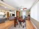 Open-concept dining and living area with hardwood floors, a dining table, and a view of the living room furniture at 11029 90Th Ave, Seminole, FL 33772