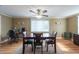 Dining room with hardwood floors, natural light from a large window, a ceiling fan, and a view of a desk space at 11029 90Th Ave, Seminole, FL 33772