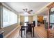 Combined dining and living area featuring wood floors, a dining set, and a view through the opening into another living space at 11029 90Th Ave, Seminole, FL 33772