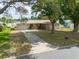 Charming single-Gathering home featuring an attached garage, mature trees, and a well-manicured lawn at 11029 90Th Ave, Seminole, FL 33772