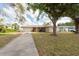 Lovely home with a driveway, attached garage, mature trees, and a well-maintained front lawn at 11029 90Th Ave, Seminole, FL 33772