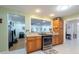 Functional kitchen featuring wooden cabinets, stainless steel oven, an open layout, and access to the adjacent rooms at 11029 90Th Ave, Seminole, FL 33772