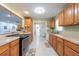 Spacious kitchen featuring wooden cabinets, stainless steel appliances, tile flooring, and an open layout to the other rooms at 11029 90Th Ave, Seminole, FL 33772