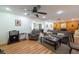 Spacious living room with ceiling fan, open layout, wood floors, and neutral decor at 11029 90Th Ave, Seminole, FL 33772