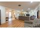 Inviting living room with wood floors, ceiling fan, open layout and neutral tones at 11029 90Th Ave, Seminole, FL 33772