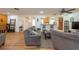 Large living room with wood floors and seating with access to the kitchen and entryway at 11029 90Th Ave, Seminole, FL 33772