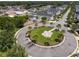 Aerial view of a community roundabout with palm trees and a playground nearby at 11227 Moultrie Pl, Tampa, FL 33625