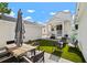 Cozy backyard with patio, outdoor dining area, grill, and artificial turf for easy maintenance at 11227 Moultrie Pl, Tampa, FL 33625