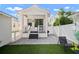 Quaint backyard showcasing artificial turf, patio space, and modern home exterior at 11227 Moultrie Pl, Tampa, FL 33625