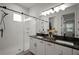 Bright bathroom features a double vanity with modern fixtures and a glass-enclosed shower at 11227 Moultrie Pl, Tampa, FL 33625