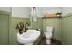 Cozy half-bathroom features charming wainscoting, a pedestal sink, and a toilet at 11227 Moultrie Pl, Tampa, FL 33625