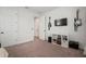 Bedroom featuring guitars, storage, carpet and door at 11227 Moultrie Pl, Tampa, FL 33625