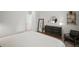 Bedroom with a plush carpet, modern furniture, natural light, and an ensuite bathroom at 11227 Moultrie Pl, Tampa, FL 33625
