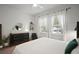 Bright bedroom with large windows, neutral tones, plush carpets, modern furniture, and white drapes at 11227 Moultrie Pl, Tampa, FL 33625