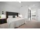 Spacious main bedroom with a king bed, accent lighting, Roman Numeral art, and an ensuite bathroom at 11227 Moultrie Pl, Tampa, FL 33625