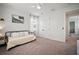 Bright bedroom with white walls, large windows, carpet and ceiling fan with double doors and doorway to a Bedroom at 11227 Moultrie Pl, Tampa, FL 33625